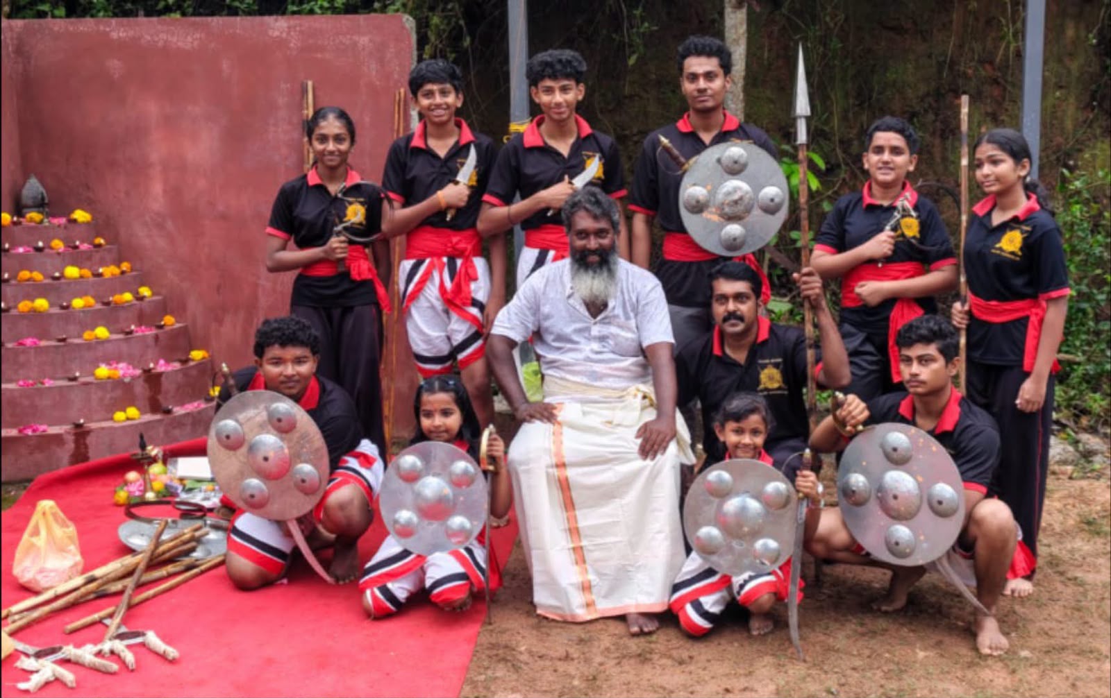 Gurukkal and students with traditional weapons
