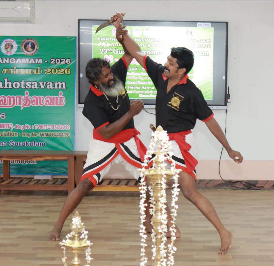 Kalaripayattu demonstration beside a traditional lamp