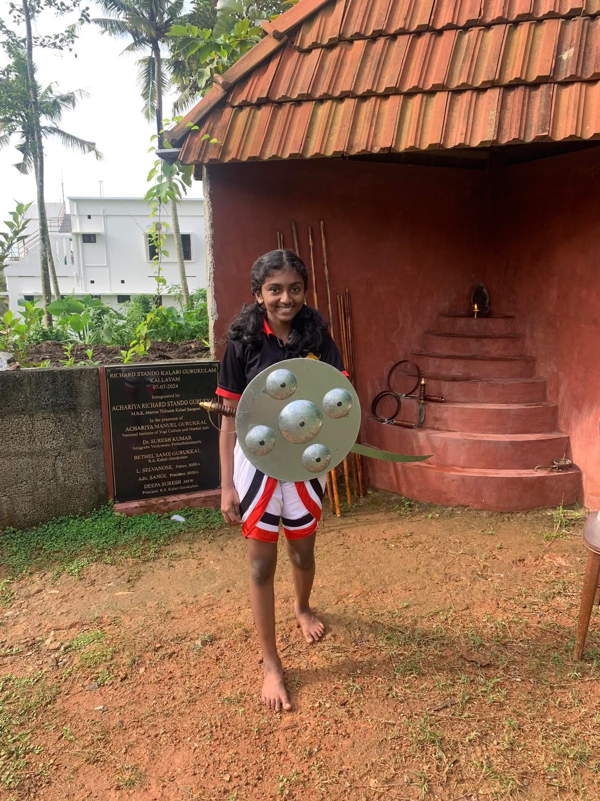 Student practising with sword and shield outdoors